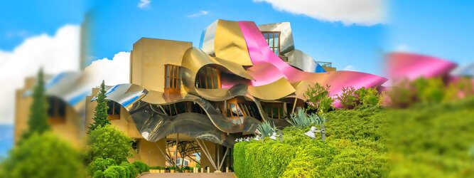 Trip Rumänien Reisetipps - Marqués de Riscal Design Hotel, Bilbao, Elciego, Spanien. Fantastisch galaktisch, unverkennbar ein Werk von Frank O. Gehry. Inmitten idyllischer Weinberge in der Rioja Region des Baskenlandes, bezaubert das schimmernde Bauobjekt mit einer Struktur bunter, edel glänzender verflochtener Metallbänder. Glanz im Baskenland - Es muss etwas ganz Besonderes sein. Emotional, zukunftsweisend, einzigartig. Denn in dieser Region, etwa 133 km südlich von Bilbao, sind Weingüter normalerweise nicht für die Öffentlichkeit zugänglich.